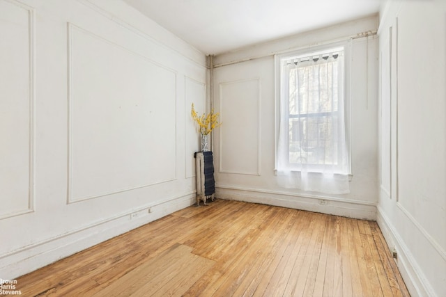 spare room with hardwood / wood-style floors