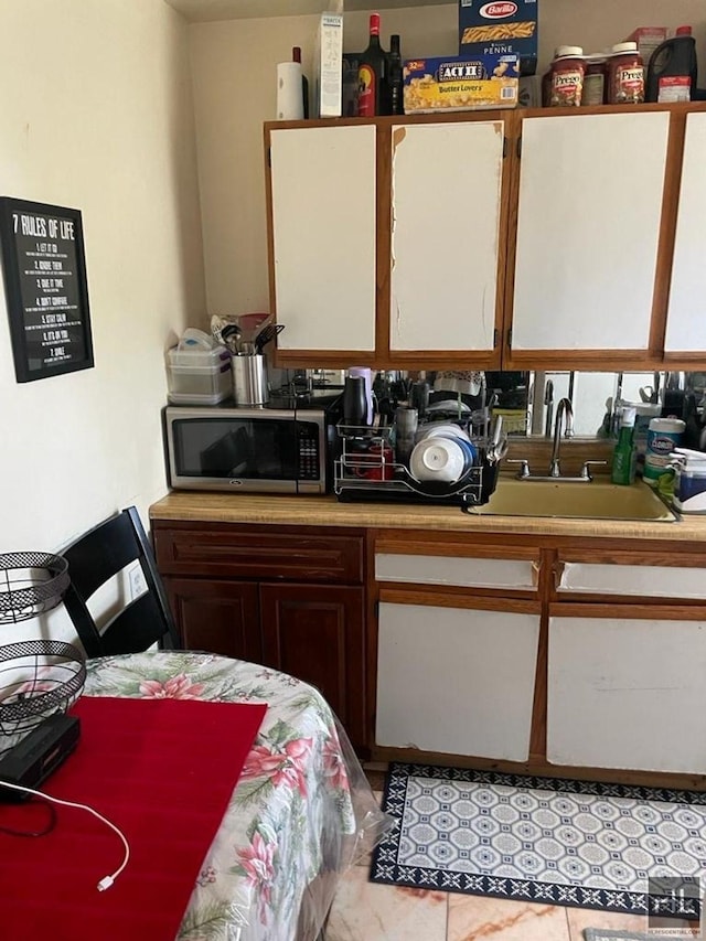 664 Osborn St Unit 1, New York City, NY 11212 - kitchen with stainless steel microwave, a sink, and light countertops