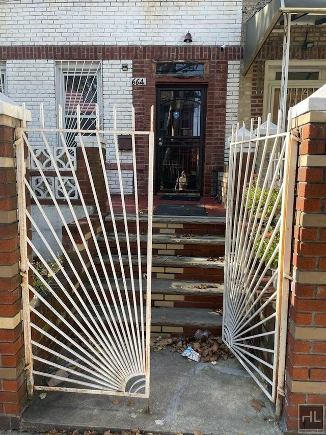 view of exterior entry with brick siding