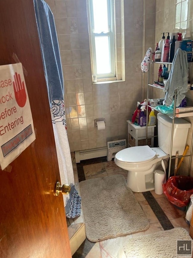 full bathroom featuring a shower with shower curtain, tile walls, toilet, and baseboard heating