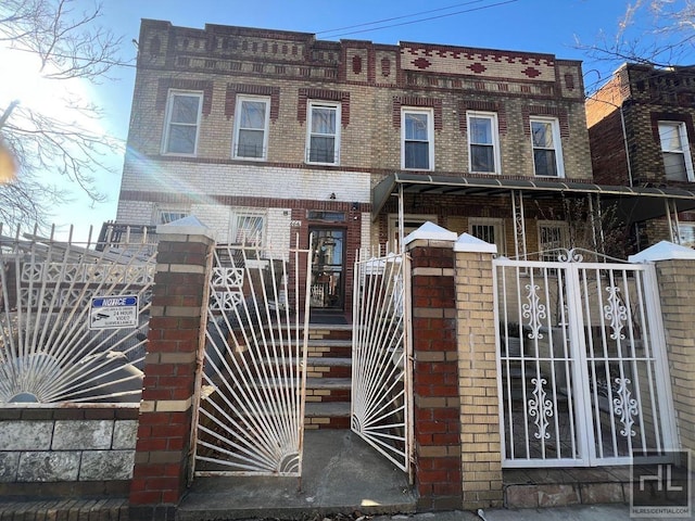 664 Osborn St Unit 1, New York City, NY 11212 - view of front facade with brick siding, a gate, and a fenced front yard