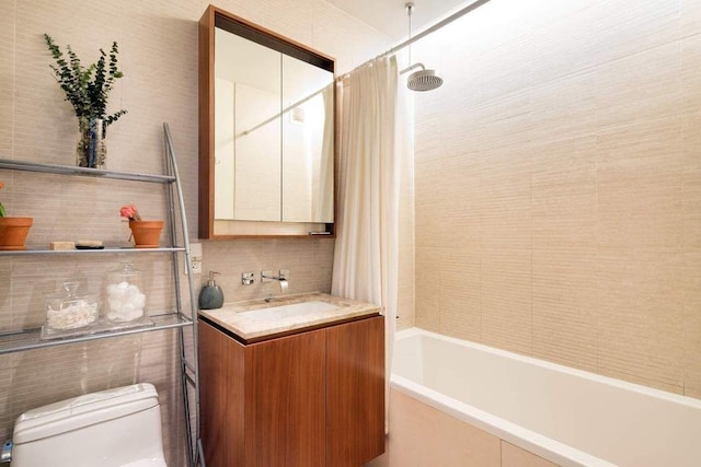 555 W 59th St Unit 12E, New York City, NY 10019 - bathroom featuring toilet, shower / tub combo with curtain, vanity, tasteful backsplash, and tile walls