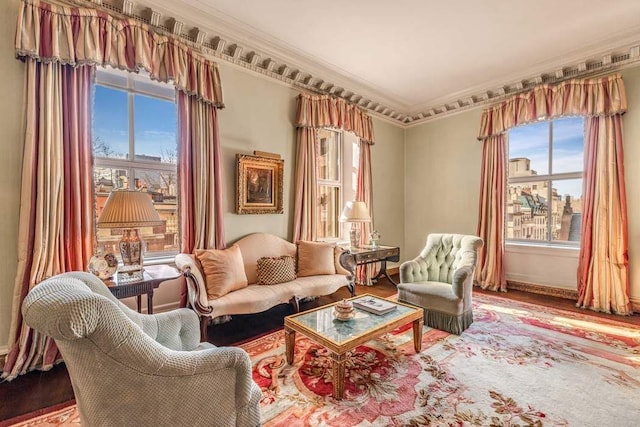 sitting room featuring a healthy amount of sunlight, wood finished floors, and crown molding