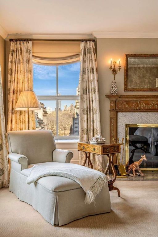 living area featuring a premium fireplace, ornamental molding, and carpet