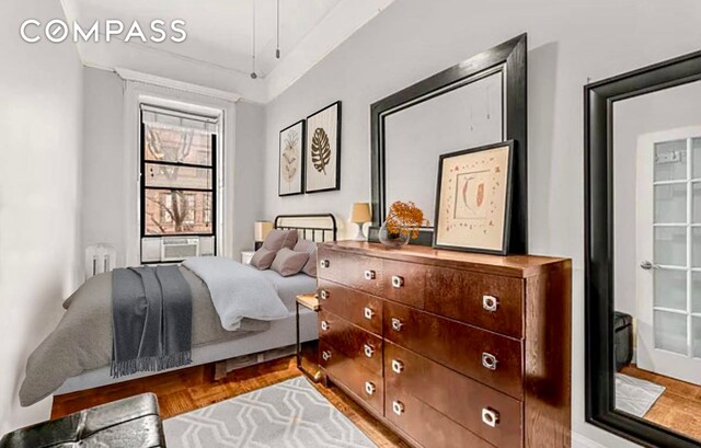 bedroom with brick wall, parquet floors, and ceiling fan