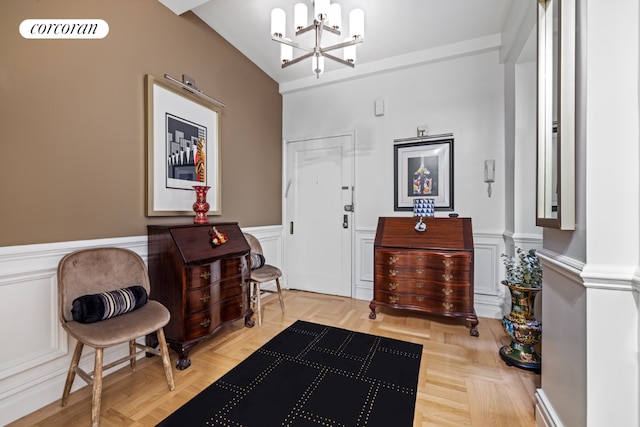 living area with a notable chandelier and light parquet floors