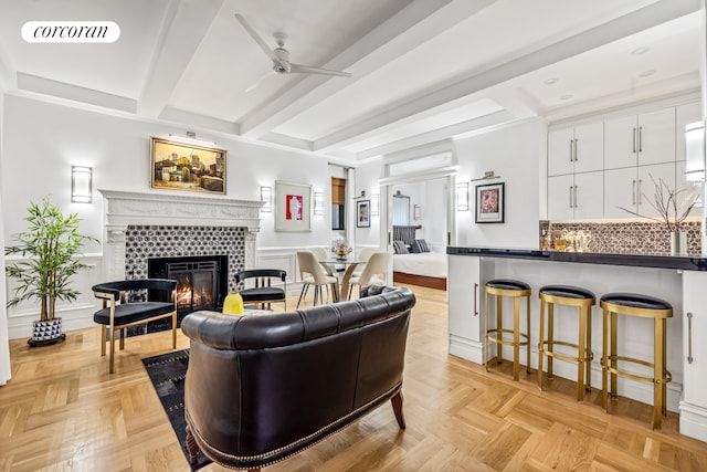 2 W 67th St Unit 3G, New York City, NY 10023 - living area featuring ceiling fan, a fireplace, beam ceiling, and visible vents
