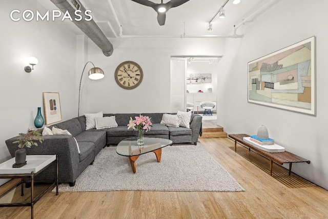 living room featuring track lighting and wood finished floors