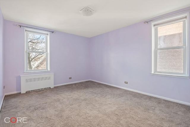 carpeted empty room with radiator heating unit