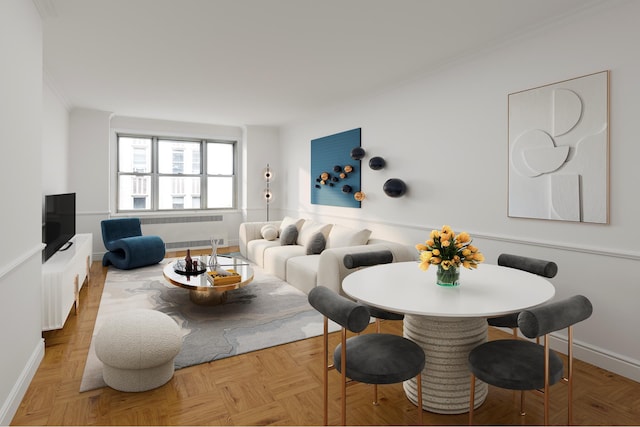 living area with ornamental molding and baseboards