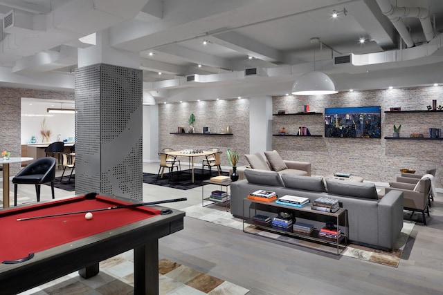 playroom with visible vents, beam ceiling, and wood finished floors