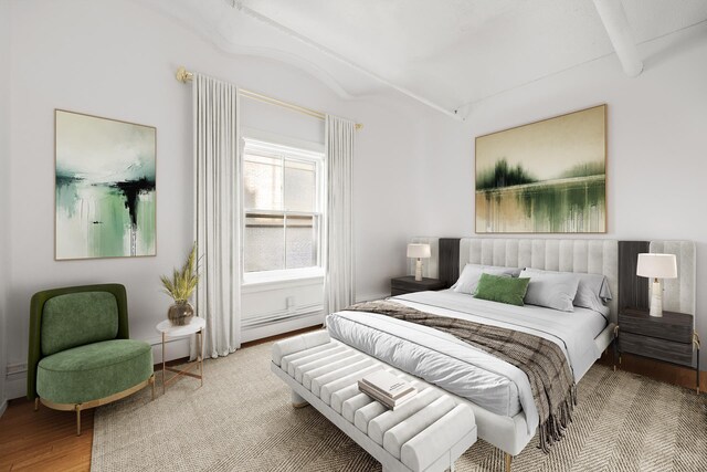 bedroom featuring lofted ceiling and light wood-type flooring