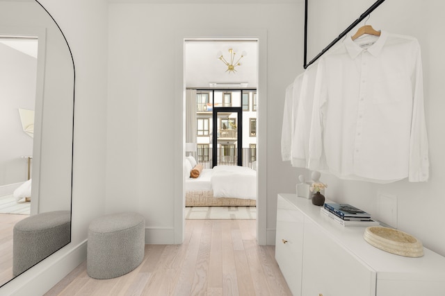 ensuite bathroom featuring connected bathroom, baseboards, and wood finished floors