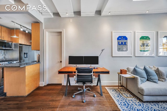 office space featuring rail lighting and dark hardwood / wood-style flooring