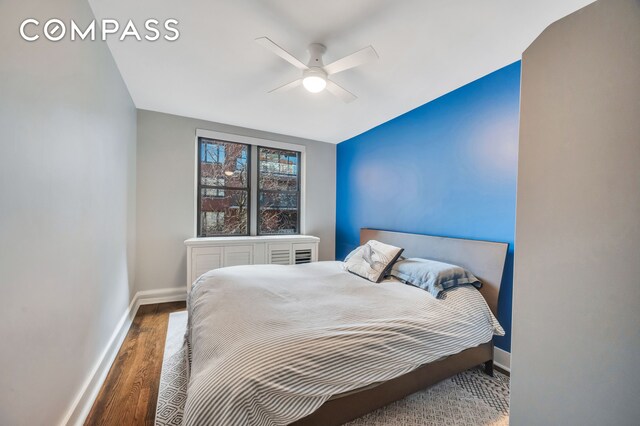 bedroom featuring ceiling fan and dark hardwood / wood-style flooring