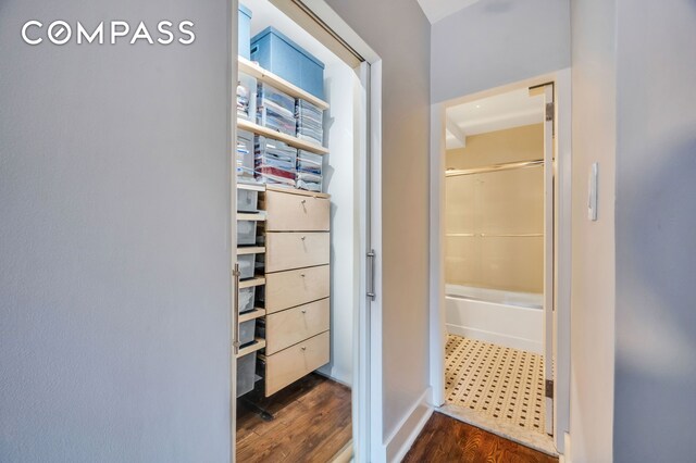 interior space with hardwood / wood-style floors and a washtub