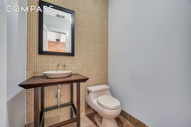 bathroom with tile patterned flooring, sink, and toilet