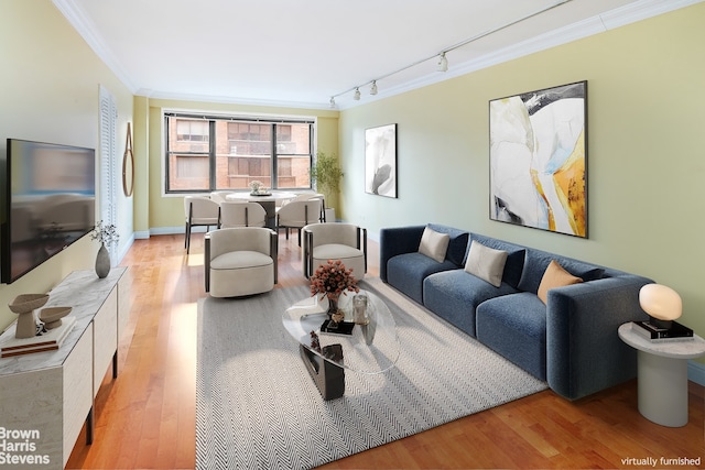 living area with ornamental molding, wood finished floors, and rail lighting