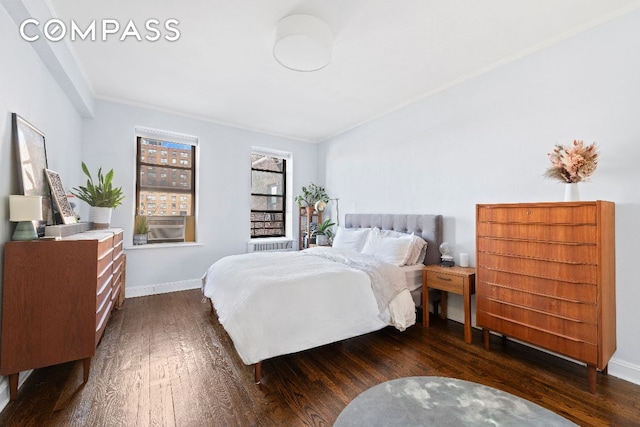 bedroom with crown molding, baseboards, and dark wood-type flooring