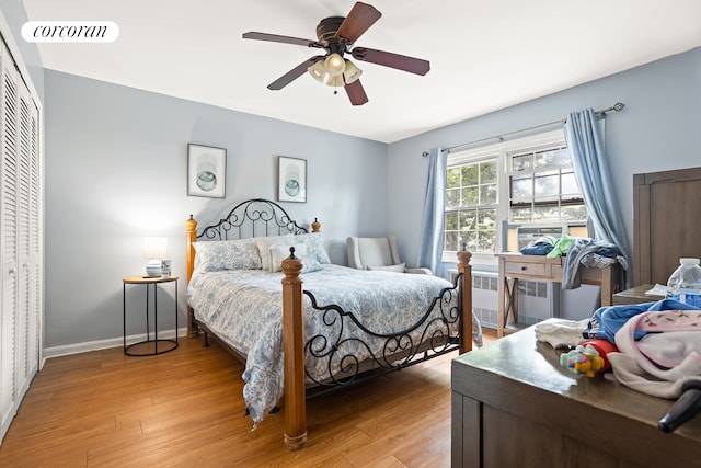 bedroom featuring radiator, baseboards, visible vents, a closet, and light wood-type flooring