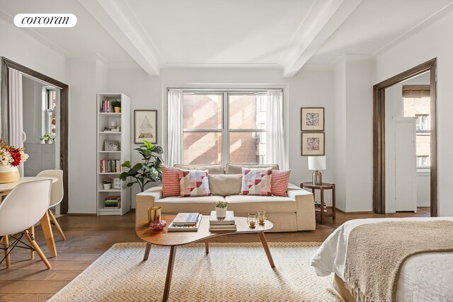 bedroom with hardwood / wood-style flooring and beam ceiling