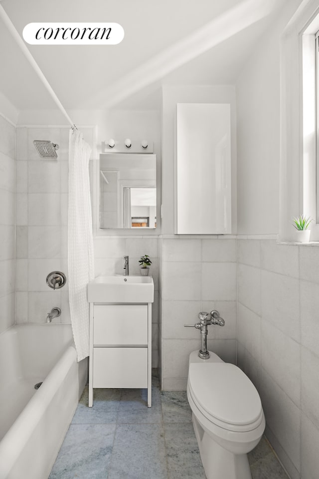 full bath with vanity, shower / tub combo with curtain, toilet, and tile walls