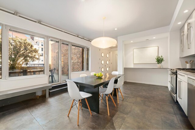 dining area featuring dark tile patterned flooring