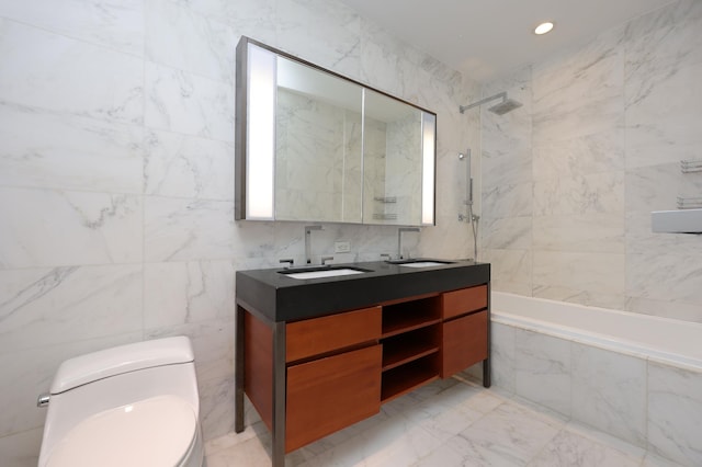 bathroom with tile walls, toilet, marble finish floor, and a sink