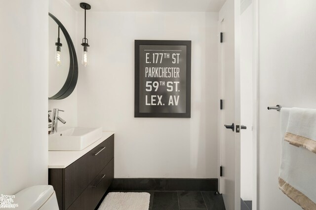 bathroom featuring vanity, toilet, and tile patterned flooring