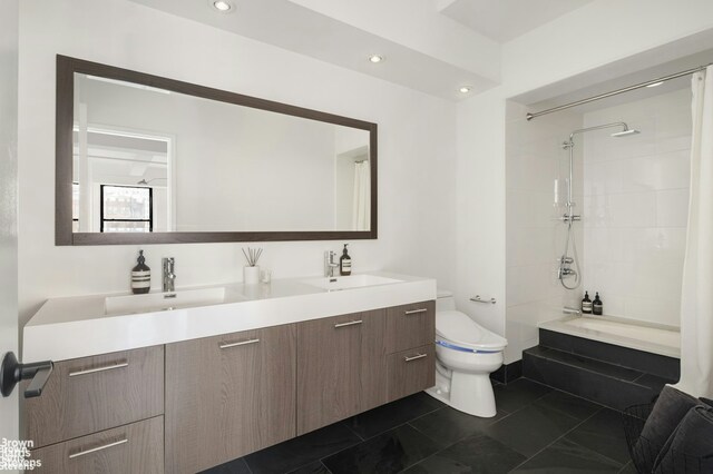 full bathroom with vanity, shower / bath combo, and toilet