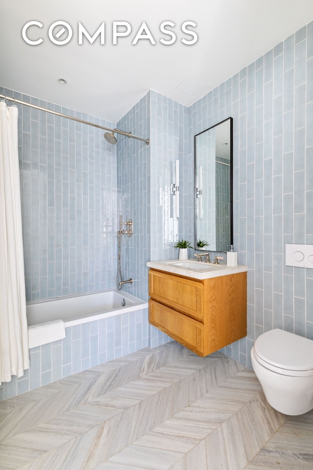 full bath with toilet, tiled shower / bath combo, tile walls, tile patterned flooring, and vanity