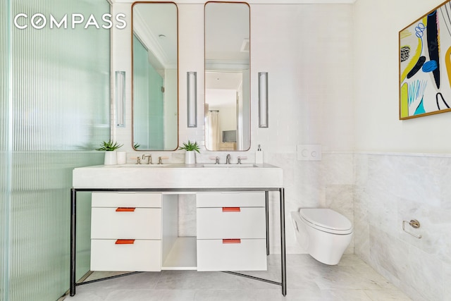 full bathroom with double vanity, a sink, tile patterned flooring, tile walls, and toilet