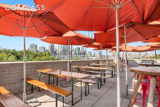 view of property's community featuring a city view and outdoor dining area