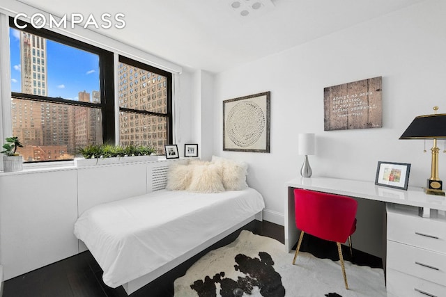 bedroom with hardwood / wood-style floors and built in desk