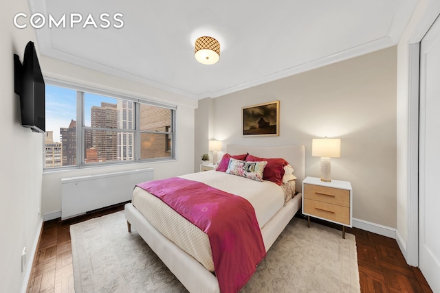 bedroom featuring crown molding, baseboards, and radiator