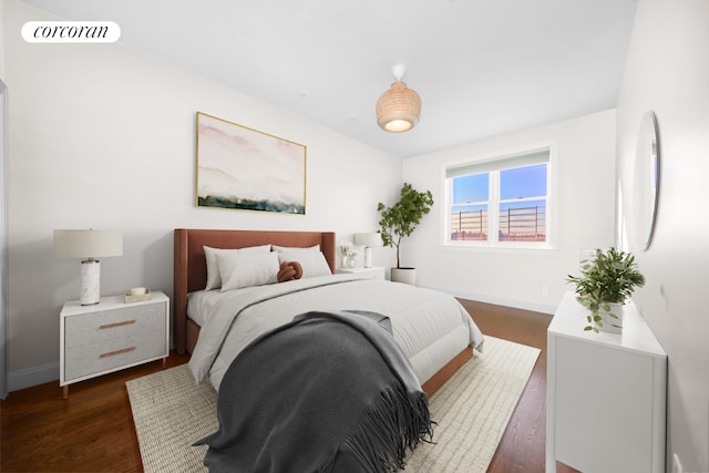 bedroom with dark hardwood / wood-style flooring