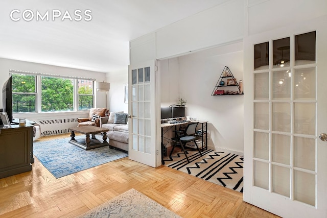 interior space with french doors, radiator heating unit, and light parquet floors