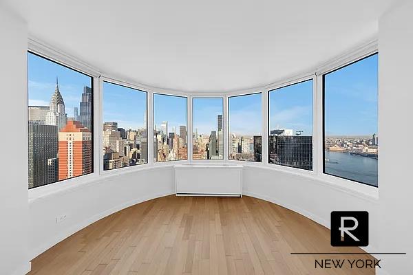 unfurnished sunroom with a water view