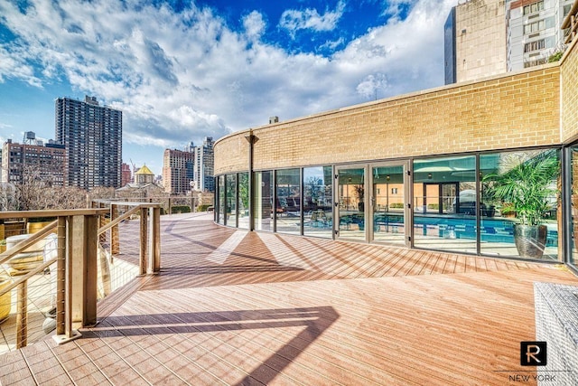 330 E 38th St Unit 54-H, New York City, NY 10016 - wooden terrace with a community pool and a view of city