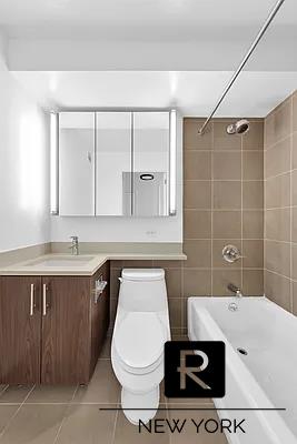 bathroom featuring tile patterned floors, toilet, shower / washtub combination, and vanity