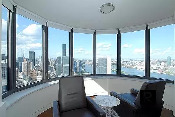 sunroom featuring a city view