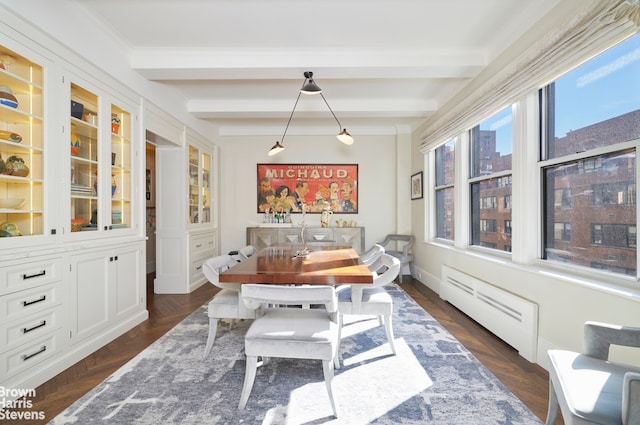 dining room with beamed ceiling, dark parquet flooring, and baseboard heating