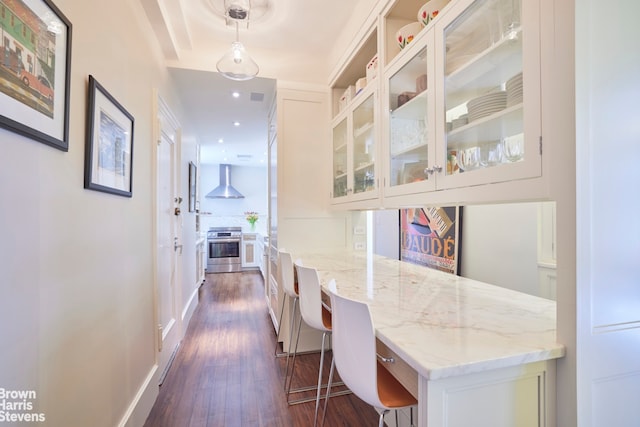 hall with dark wood-style floors, recessed lighting, and baseboards