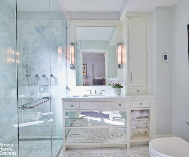 bathroom with vanity, an enclosed shower, and tile patterned flooring