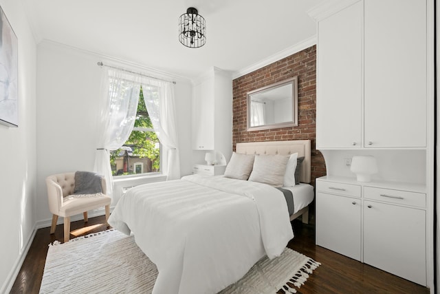 bedroom with crown molding, dark wood-style flooring, and brick wall