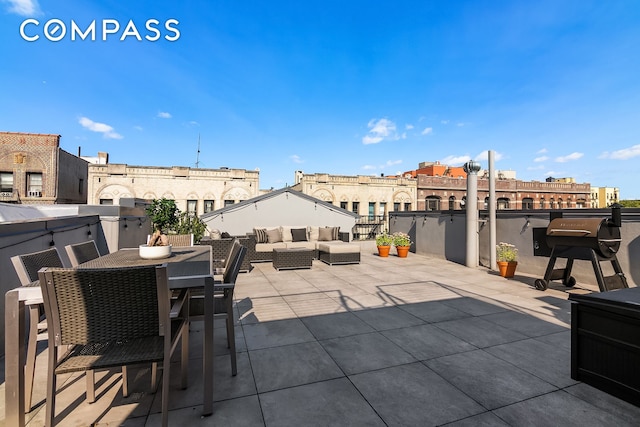 view of patio / terrace with an outdoor living space, outdoor dining area, and a grill