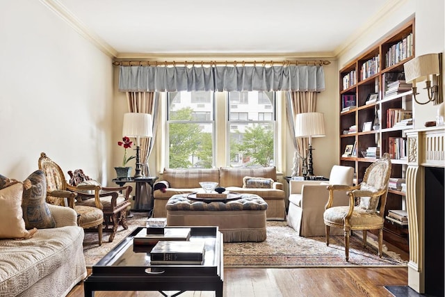 sitting room with ornamental molding and wood-type flooring