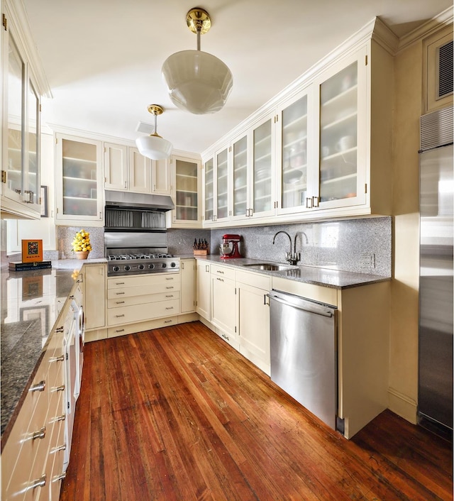 925 Park Ave Unit 2A, New York City, NY 10075 - kitchen featuring stainless steel appliances, a sink, dark wood-style floors, and decorative backsplash