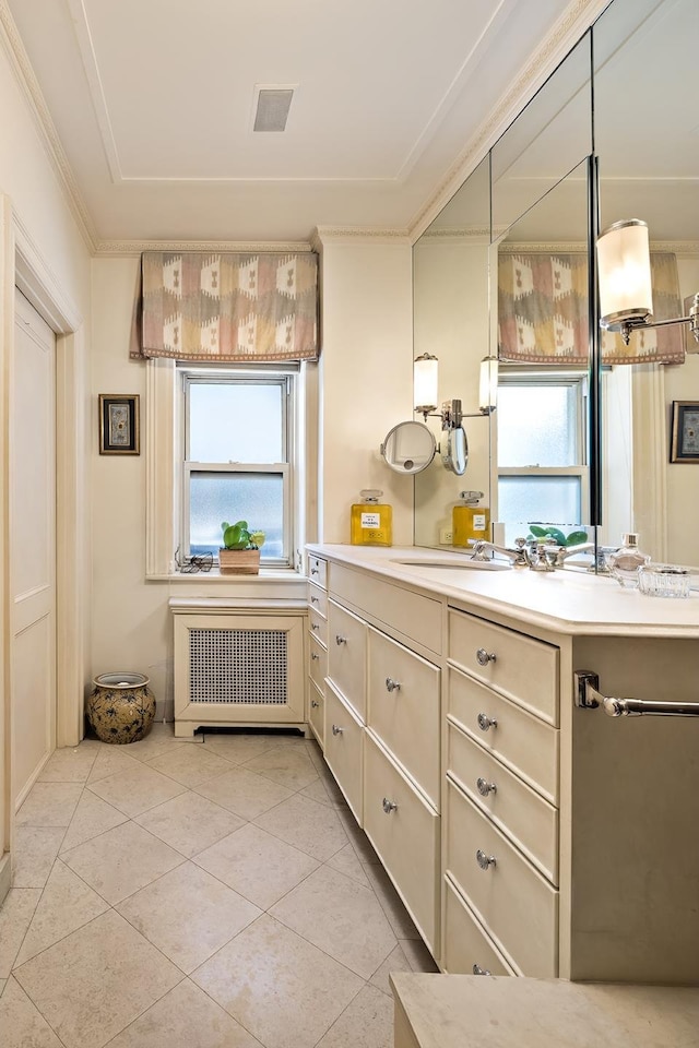 925 Park Ave Unit 2A, New York City, NY 10075 - bathroom with radiator, ornamental molding, plenty of natural light, vanity, and tile patterned floors