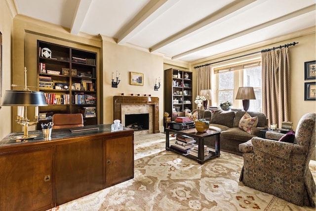 living room featuring beamed ceiling, a fireplace, and built in features